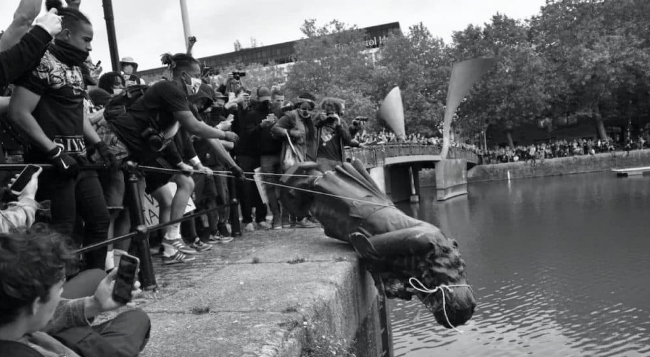The statue of slave trader Edward Colston getting toppled into the water by Black Lives Matter protestors in Bristol in the aftermath of the murder of George Floyd in June 2020.