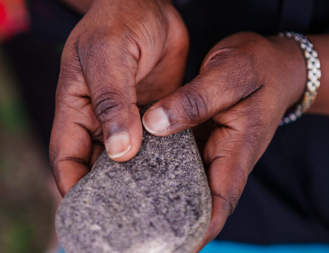 Images of hands holding stone